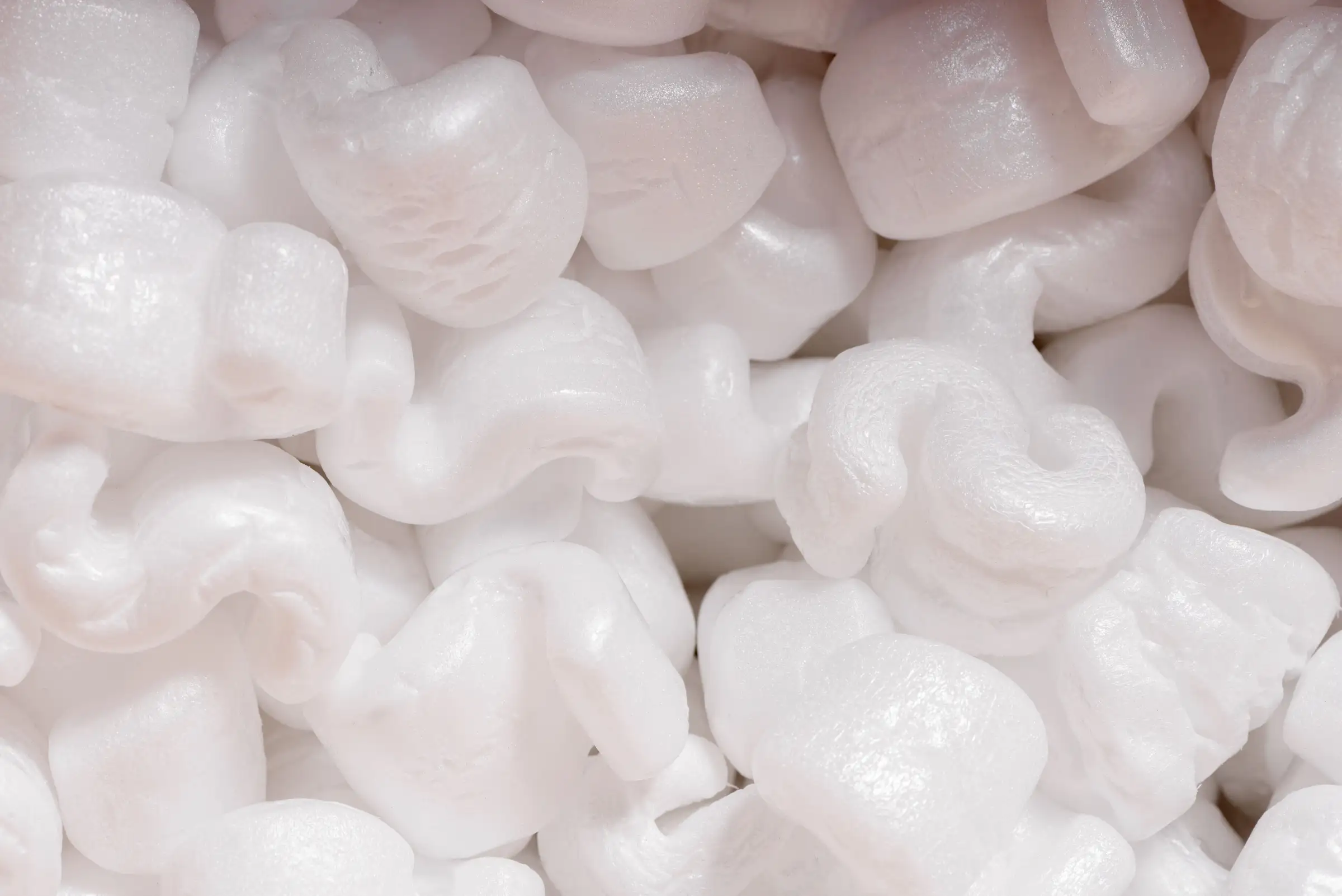 Can Styrofoam Be Recycled Close-up of white Styrofoam packing peanuts used as loose-fill packaging