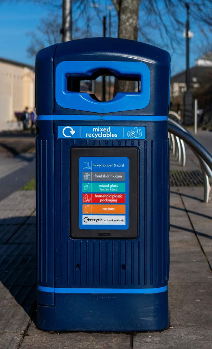 Blue bin of mixed recyclables with sorting labels