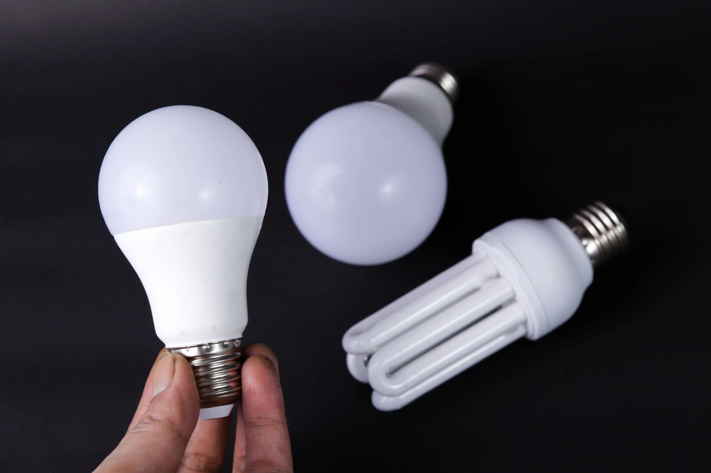 CFL and LED Bulbs Side by Side A spiral CFL bulb next to LED-style bulbs, the two types readers need to tell apart before dropping them at a store take-back counter