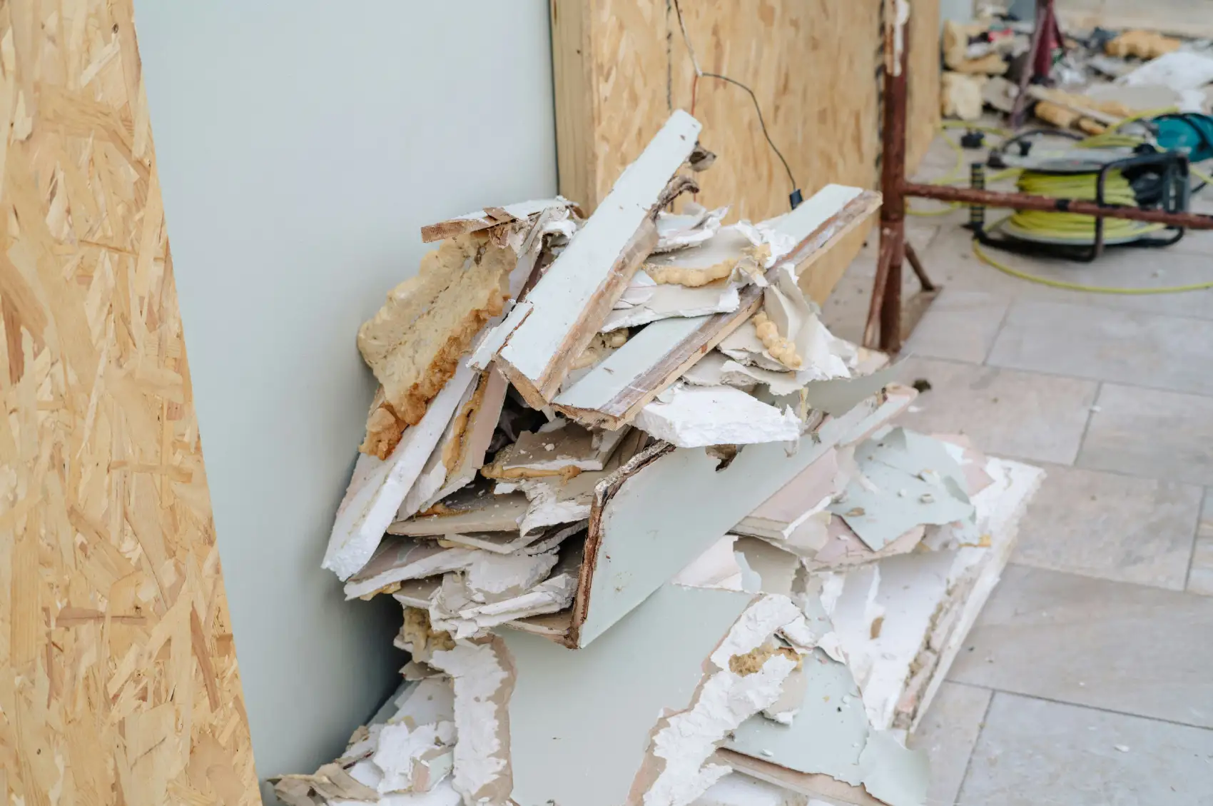 Pile of broken drywall, wood trim and foam insulation from a home renovation